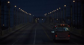 Movie still from “Ghost World” (2001), directed by Terry Zwigoff – A bus driving down a street at night; Extreme Wide shot, High angle