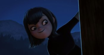 Movie still from “Hotel Transylvania” (2012), directed by Genndy Tartakovsky – A woman is smiling while holding a pole in her hand; Medium shot, Low angle