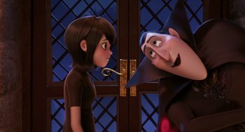 Movie still from “Hotel Transylvania” (2012), directed by Genndy Tartakovsky – A woman and a man looking at each other in front of a door; Medium shot, Over the shoulder angle