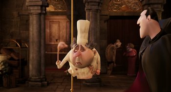 Movie still from “Hotel Transylvania” (2012), directed by Genndy Tartakovsky – An animated character is hanging upside down on a pole; Medium shot, Low angle