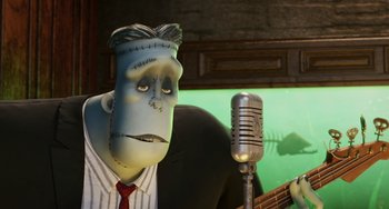 Movie still from “Hotel Transylvania” (2012), directed by Genndy Tartakovsky – A man with a microphone and a microphone stand; Medium shot, Low angle