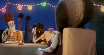 Movie still from “Hotel Transylvania” (2012), directed by Genndy Tartakovsky – A woman sitting at a table next to another woman; Medium shot, Over the shoulder angle