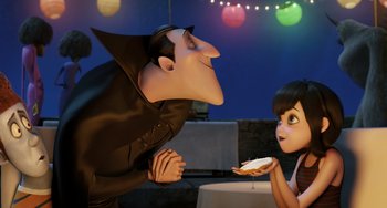 Movie still from “Hotel Transylvania” (2012), directed by Genndy Tartakovsky – A man and a woman are eating cake together; Medium shot, Over the shoulder angle