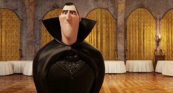 Movie still from “Hotel Transylvania” (2012), directed by Genndy Tartakovsky – A man dressed in a dracula costume standing in front of a wall; Medium shot, Low angle