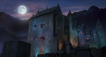 An old castle is lit up at night with a full moon in the background