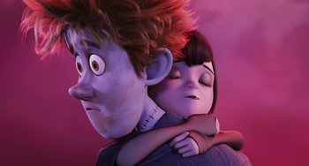 Movie still from “Hotel Transylvania” (2012), directed by Genndy Tartakovsky – A man and a woman hugging each other in front of a purple background; Medium shot, Low angle