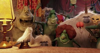 Movie still from “Hotel Transylvania” (2012), directed by Genndy Tartakovsky – A group of green and white stuffed animals in front of a wooden table; Medium shot, Low angle