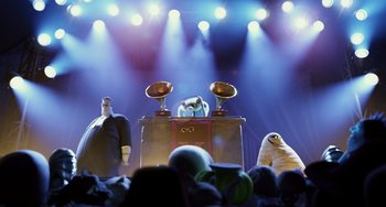 Movie still from “Hotel Transylvania” (2012), directed by Genndy Tartakovsky – A group of people standing in front of a stage; Wide shot, Low angle