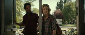 Movie still from “Ghostbusters: Afterlife” (2021), directed by Jason Reitman – A woman and a man standing next to each other on a bus; Medium shot, Low angle