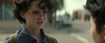 Movie still from “Ghostbusters: Afterlife” (2021), directed by Jason Reitman – A young woman wearing glasses and a backpack; Close Up shot, Over the shoulder angle
