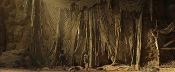 Movie still from “Ghostbusters: Afterlife” (2021), directed by Jason Reitman – Two people standing in front of a wall covered in fabric; Extreme Wide shot, Low angle