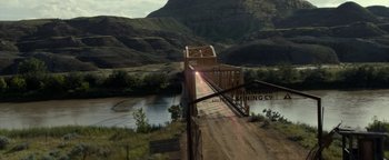 Movie still from “Ghostbusters: Afterlife” (2021), directed by Jason Reitman – A train crossing a bridge over a river in the mountains; Extreme Wide shot, High angle