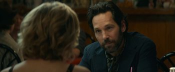 Movie still from “Ghostbusters: Afterlife” (2021), directed by Jason Reitman – A man sitting in front of a woman in front of a mirror; Close Up shot, Over the shoulder angle