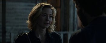 Movie still from “Ghostbusters: Afterlife” (2021), directed by Jason Reitman – A woman with blonde hair is standing in a dark room; Close Up shot, Over the shoulder angle
