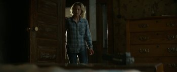 Movie still from “Ghostbusters: Afterlife” (2021), directed by Jason Reitman – A woman standing in front of an open door; Medium shot, Over the shoulder angle