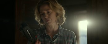 Movie still from “Ghostbusters: Afterlife” (2021), directed by Jason Reitman – A woman in a plaid shirt holding a pair of scissors; Close Up shot, Over the shoulder angle