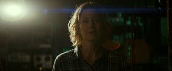 Movie still from “Ghostbusters: Afterlife” (2021), directed by Jason Reitman – A woman in a plaid shirt is looking at the camera; Close Up shot, Over the shoulder angle