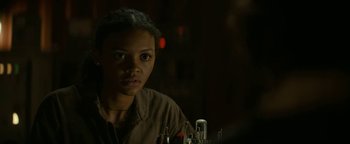 Movie still from “Ghostbusters: Afterlife” (2021), directed by Jason Reitman – A woman in a brown shirt is looking at the camera; Close Up shot, Over the shoulder angle