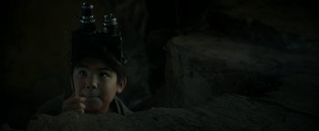 Movie still from “Ghostbusters: Afterlife” (2021), directed by Jason Reitman – A young boy wearing a hat and holding a bottle; Close Up shot, Low angle