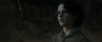 Movie still from “Ghostbusters: Afterlife” (2021), directed by Jason Reitman – A woman wearing glasses and a brown jacket; Close Up shot, Low angle