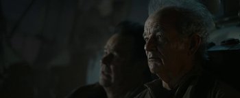 Movie still from “Ghostbusters: Afterlife” (2021), directed by Jason Reitman – Two older men looking at something in the dark; Close Up shot, Low angle