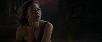 Movie still from “Ghostbusters: Afterlife” (2021), directed by Jason Reitman – A person sitting on the ground near a building; Close Up shot, Low angle