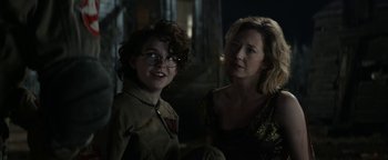 Movie still from “Ghostbusters: Afterlife” (2021), directed by Jason Reitman – A woman standing next to a man in a room; Close Up shot, Over the shoulder angle