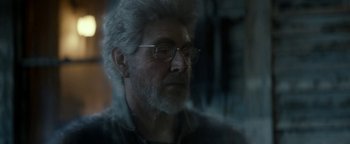 Movie still from “Ghostbusters: Afterlife” (2021), directed by Jason Reitman – An older man wearing glasses looking at the camera; Close Up shot, Over the shoulder angle