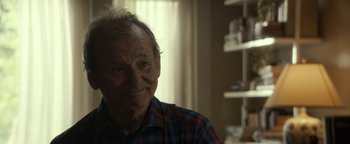 Movie still from “Ghostbusters: Afterlife” (2021), directed by Jason Reitman – An older man is smiling for the camera; Close Up shot, Over the shoulder angle