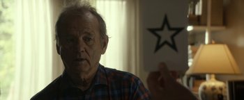 Movie still from “Ghostbusters: Afterlife” (2021), directed by Jason Reitman – An older man sitting in front of a window; Close Up shot, Over the shoulder angle