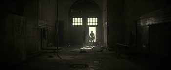 Movie still from “Ghostbusters: Afterlife” (2021), directed by Jason Reitman – A man standing in a doorway in an abandoned building; Extreme Wide shot, Low angle