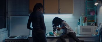 Movie still from “Girlhood” (2014), directed by Céline Sciamma – A man and a woman in a kitchen preparing food; Medium shot, Low angle