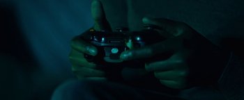 Movie still from “Girlhood” (2014), directed by Céline Sciamma – A person is holding a video game controller in their hands; Extreme Close Up shot, Overhead angle