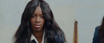 Movie still from “Girlhood” (2014), directed by Céline Sciamma – A person with long black hair; Close Up shot, Over the shoulder angle