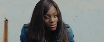 Movie still from “Girlhood” (2014), directed by Céline Sciamma – A person with long black hair; Close Up shot, High angle