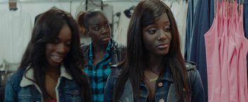 Movie still from “Girlhood” (2014), directed by Céline Sciamma – A group of women standing next to each other in a room; Close Up shot, Over the shoulder angle
