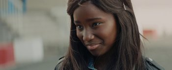 Movie still from “Girlhood” (2014), directed by Céline Sciamma – A person with long brown hair; Close Up shot, Over the shoulder angle