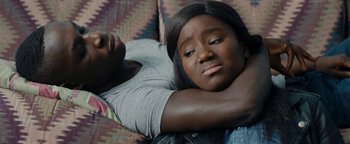 Movie still from “Girlhood” (2014), directed by Céline Sciamma – A woman laying on a couch with her head resting on a pillow; Close Up shot, High angle