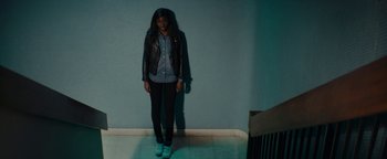 Movie still from “Girlhood” (2014), directed by Céline Sciamma – A person standing in a room with a wall in the background; Wide shot, High angle