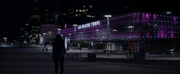 Movie still from “Girlhood” (2014), directed by Céline Sciamma – A person standing in front of a building at night; Extreme Wide shot, Low angle
