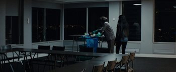 Movie still from “Girlhood” (2014), directed by Céline Sciamma – A person in a room with a table; Wide shot, Over the shoulder angle