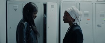 Movie still from “Girlhood” (2014), directed by Céline Sciamma – Two women standing next to each other in front of lockers; Close Up shot, Over the shoulder angle