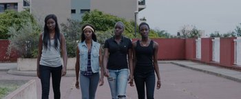 Movie still from “Girlhood” (2014), directed by Céline Sciamma – A group of women walking down a street; Medium shot, Low angle