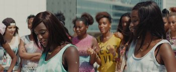 Movie still from “Girlhood” (2014), directed by Céline Sciamma – A group of young women standing next to each other on the street; Close Up shot, Over the shoulder angle