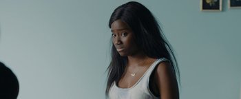 Movie still from “Girlhood” (2014), directed by Céline Sciamma – A woman with long black hair wearing a tank top; Close Up shot, High angle