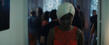 Movie still from “Girlhood” (2014), directed by Céline Sciamma – A woman with a white turban on her head; Close Up shot, Over the shoulder angle