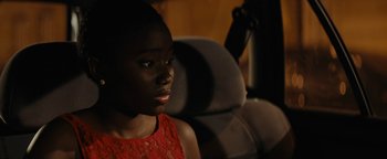 Movie still from “Girlhood” (2014), directed by Céline Sciamma – A woman sitting in the back seat of a car; Close Up shot, Over the shoulder angle