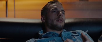 Movie still from “Girlhood” (2014), directed by Céline Sciamma – A person sitting on a couch; Close Up shot, Low angle