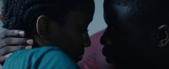 Movie still from “Girlhood” (2014), directed by Céline Sciamma – Two young boys looking at each other in the dark; Extreme Close Up shot, Over the shoulder angle