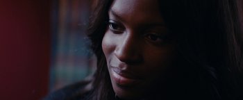 Movie still from “Girlhood” (2014), directed by Céline Sciamma – A woman's face in the dark; Close Up shot, Over the shoulder angle